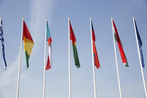 Flags of different countries against the sky Stock Photos