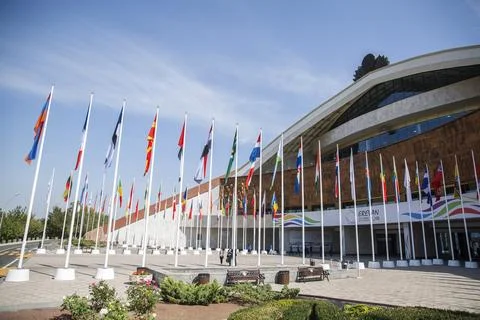 Flags of different countries against the sky Stock Photos