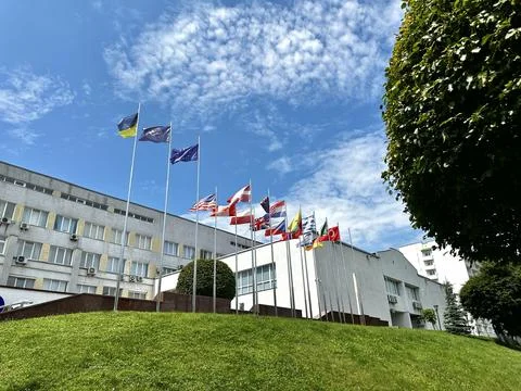 Flags of different countries together on flagpoles Stock Photos