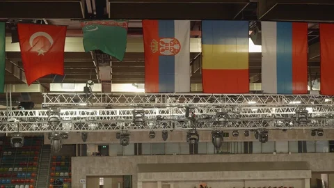 Flags of different countries under ceiling near lighting apparatus. Stock Footage 110702739