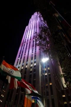 Flags of different nations in front of Rockefeller Center at night Stock Photos