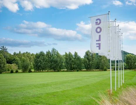 Flags at driving range for practicing golf swing. Nice landscape in sunny day Stock-Fotos