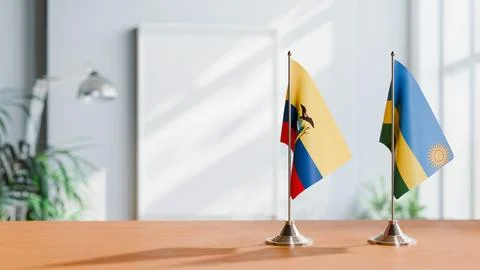 FLAGS OF ECUADOR AND RWANDA ON TABLE Stock Photos