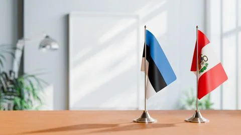 FLAGS OF ESTONIA AND PERU ON TABLE Stock Photos