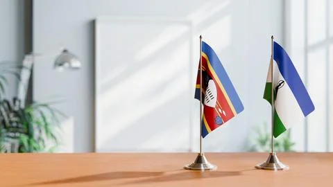 FLAGS OF ESWATINI AND LESOTHO ON TABLE Stock Photos