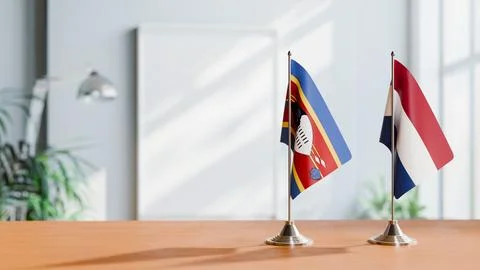 FLAGS OF ESWATINI AND NETHERLANDS ON TABLE Stock Photos