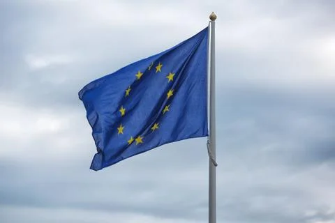 Flags of EU on blue sky. Concepts of politics, tourism, economy, cooperation, Stock Photos