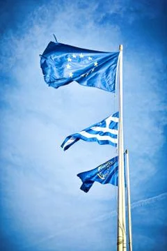 Flags , EU, Greece waving in the wind against the sky Stock Photos
