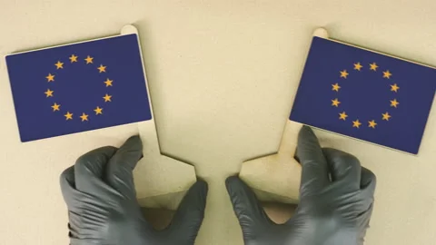 Flags of the EU made of recycled paper on the cardboard table Stock Footage 141896719