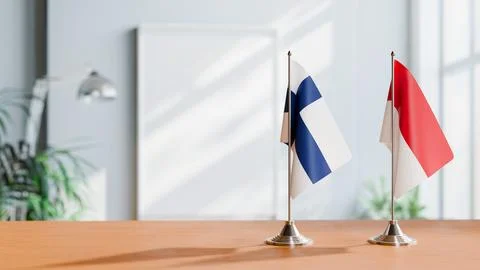 FLAGS OF FINLAND AND MONACO ON TABLE Stock Photos