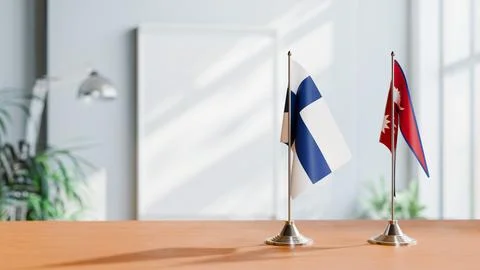FLAGS OF FINLAND AND NEPAL ON TABLE Stock Photos