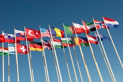 Flags on flagpoles fluttering in the wind Stock Photos