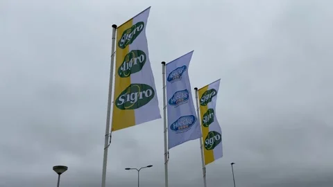  Flags flutter in the wind in front the Dutch company Sligro.  Stock Footage 146131927