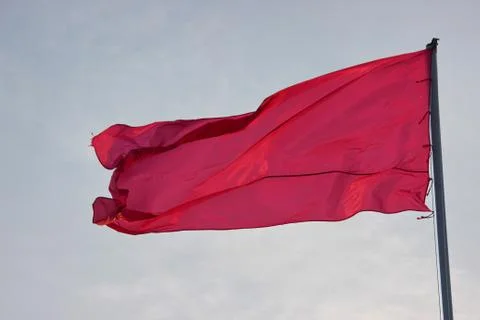 Flags flutter in the wind on a Sunny day against the backdrop of the urban la Stock Photos