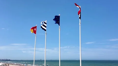 Flags fluttering along Dunkirk beach France 動画素材 342815527