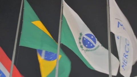 Flags fluttering in the wind at night mercosul paraná Stock Footage 102998153