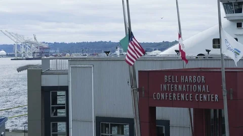 Flags fly at Bell harbor international conference center. Stock Footage 73497244