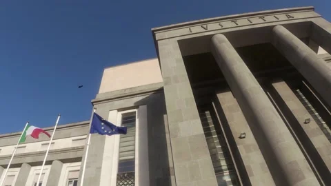 Flags Fly In Front Of The Facade Of A Courthouse. Stock Footage 149125985