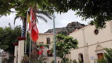 Flags fly outside typically Spanish church Stock Footage 85877462