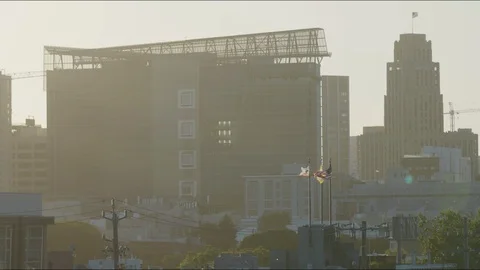 Flags fly in slow motion at sunset in San Francisco Stock Footage 129523771