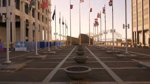 Flags fly in wind in downtown scene late afternoon tilting up 스톡 동영상 104139874