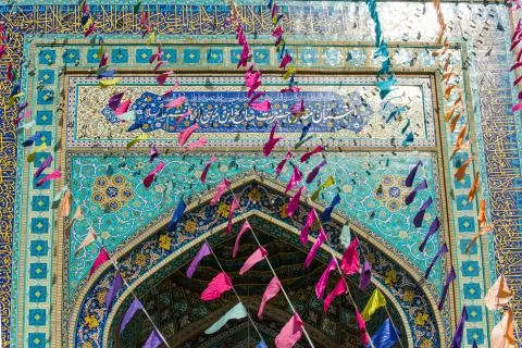 Flags flying in front of the colorful mosque Stock Photos
