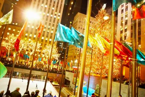 Flags flying over rockefeller center at night, new york, new york, united states Stock Photos