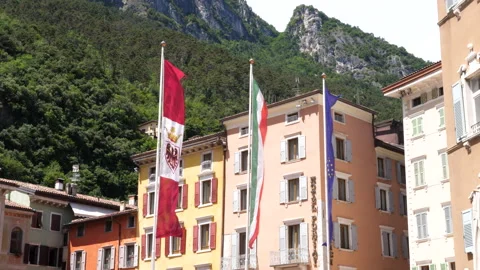 Flags flying in town square piazza at Riva del Garda, Italy Stock Footage 317508658