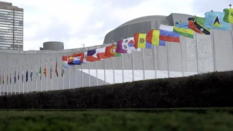 Flags flying in the wind, slow motion flags in front of United Nations in NYC Stock Footage 176109521