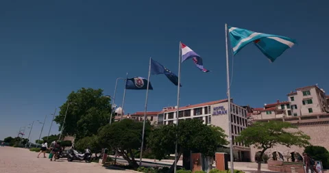 Flags in Front of Hotel Jadran on Sibenik Waterfront Video stock 336605868