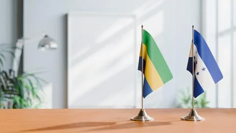 FLAGS OF GABON AND HONDURAS ON TABLE Stock Photos