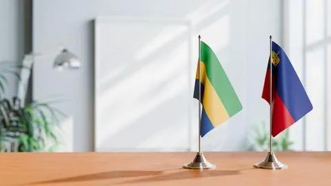 FLAGS OF GABON AND LIECHTENSTEIN ON TABLE Stock Photos
