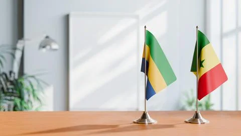 FLAGS OF GABON AND SENEGAL ON TABLE Stock Photos