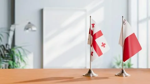 FLAGS OF GEORGIA AND MALTA ON TABLE Stock Photos
