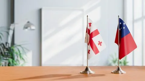 FLAGS OF GEORGIA AND SAMOA ON TABLE Stock Photos