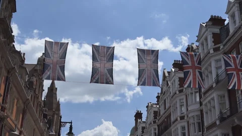 Flags of the Great Britain hanging across a high street in London. Stock Footage 281366573