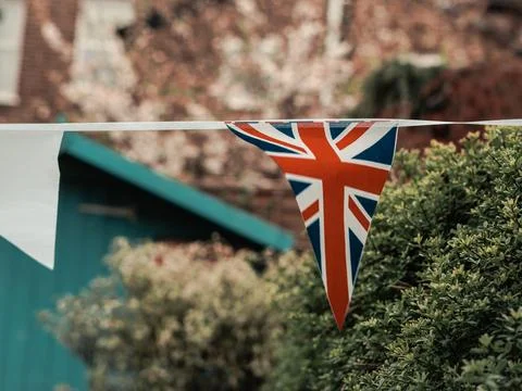 Flags of Great Britain waving on the wind in the garden of English Stock Photos