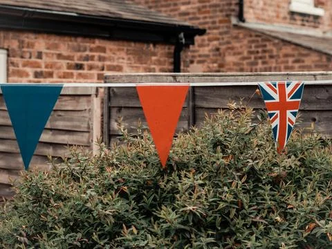 Flags of Great Britain waving on the wind in the garden of English Stock Photos