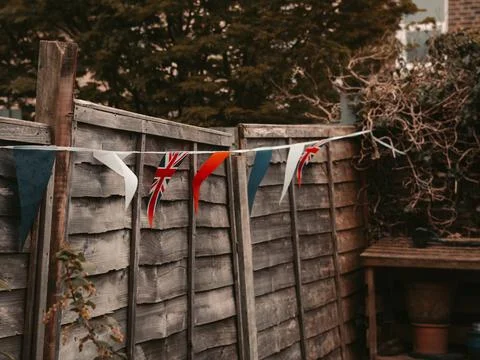Flags of Great Britain waving on the wind in the garden of English Stock Photos