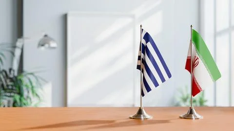 FLAGS OF GREECE AND IRAN ON TABLE Stock Photos
