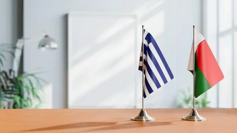 FLAGS OF GREECE AND MADAGASCAR ON TABLE Stock Photos