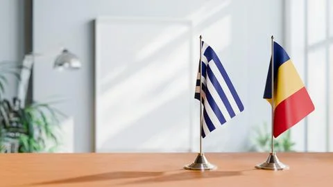 FLAGS OF GREECE AND ROMANIA ON TABLE Stock Photos