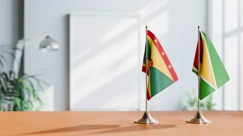 FLAGS OF GRENADA AND GUYANA ON TABLE Stock Photos