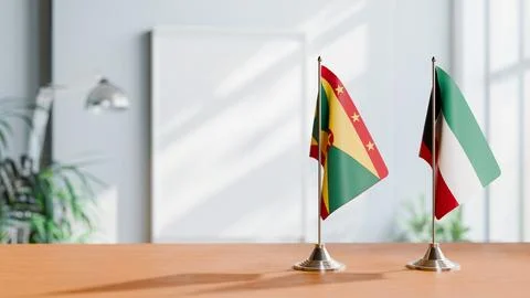 FLAGS OF GRENADA AND KUWAIT ON TABLE Stock Photos