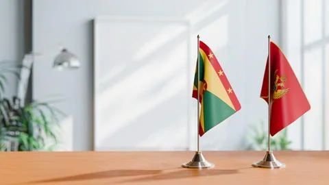 FLAGS OF GRENADA AND MONTENEGRO ON TABLE Stock Photos