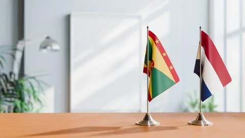 FLAGS OF GRENADA AND NETHERLANDS ON TABLE Stock Photos