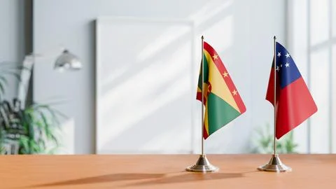 FLAGS OF GRENADA AND SAMOA ON TABLE Stock Photos
