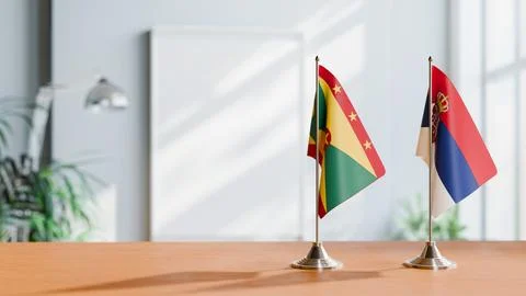 FLAGS OF GRENADA AND SERBIA ON TABLE Stock Photos