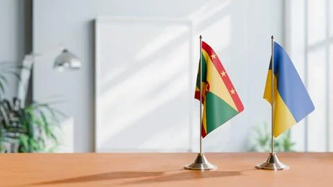 FLAGS OF GRENADA AND UKRAINE ON TABLE Stock Photos