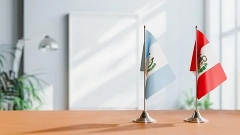 FLAGS OF GUATEMALA AND PERU ON TABLE Stock Photos
